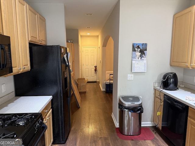 kitchen featuring dark wood-type flooring, black appliances, and light brown cabinets