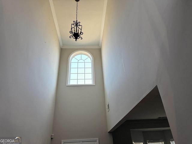 details featuring an inviting chandelier and crown molding