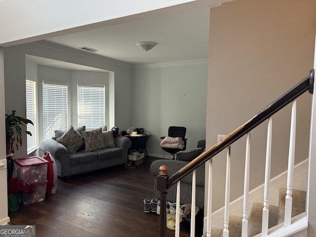 living room featuring dark hardwood / wood-style flooring and ornamental molding