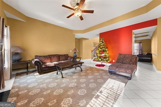 living room with ceiling fan and light tile patterned flooring