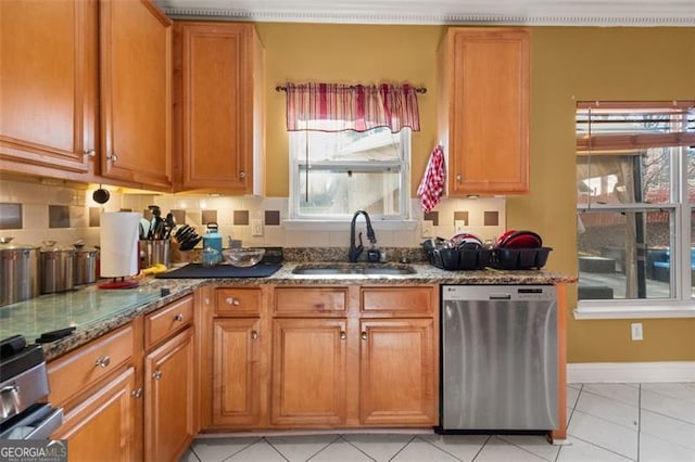 kitchen featuring dishwasher, sink, backsplash, stone countertops, and light tile patterned floors