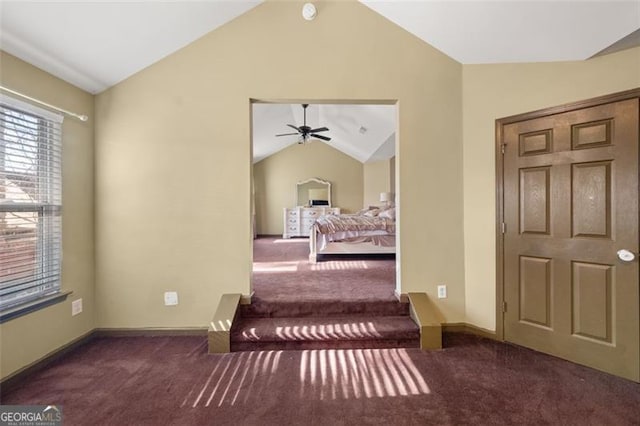 carpeted bedroom with lofted ceiling