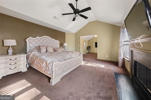 bedroom with dark colored carpet, ceiling fan, and lofted ceiling