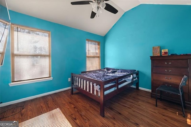 bedroom with ceiling fan, dark wood-type flooring, and vaulted ceiling