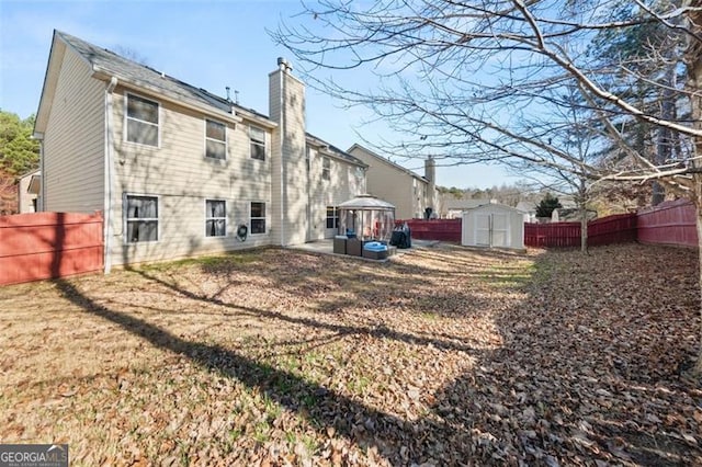 back of property featuring a storage unit