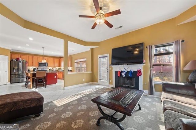 tiled living room with ceiling fan