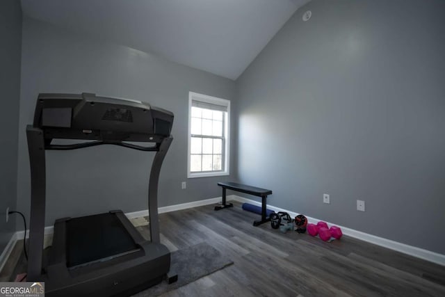 workout area with hardwood / wood-style floors and vaulted ceiling