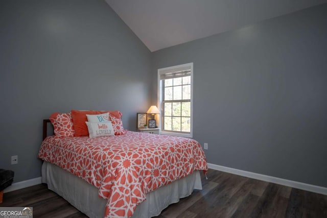 bedroom with dark wood-type flooring and vaulted ceiling