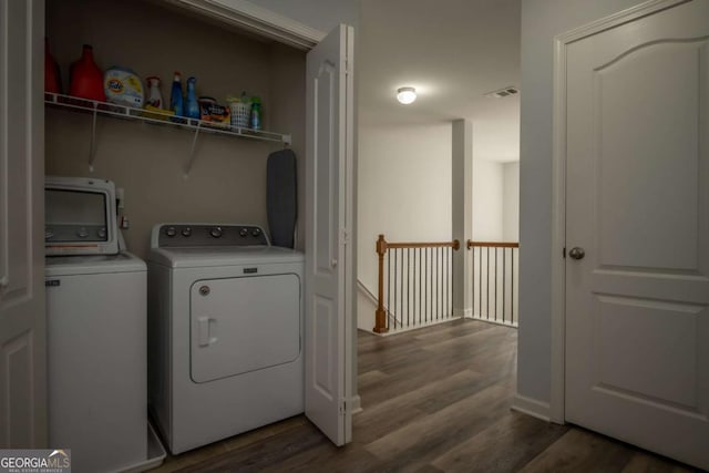 clothes washing area with independent washer and dryer and dark hardwood / wood-style floors