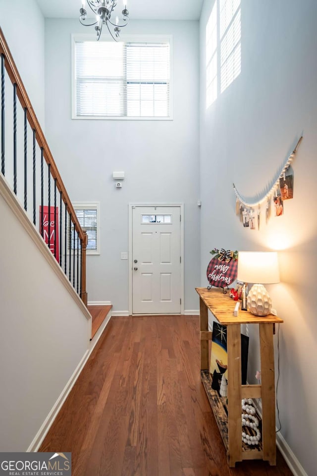 entrance foyer featuring hardwood / wood-style flooring and an inviting chandelier