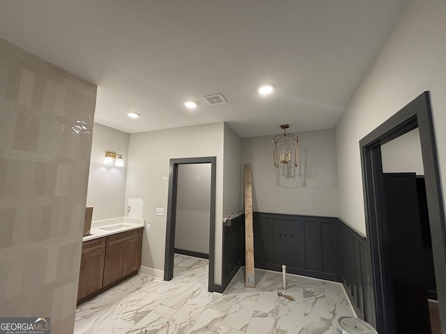 bathroom with marble finish floor, recessed lighting, visible vents, wainscoting, and vanity