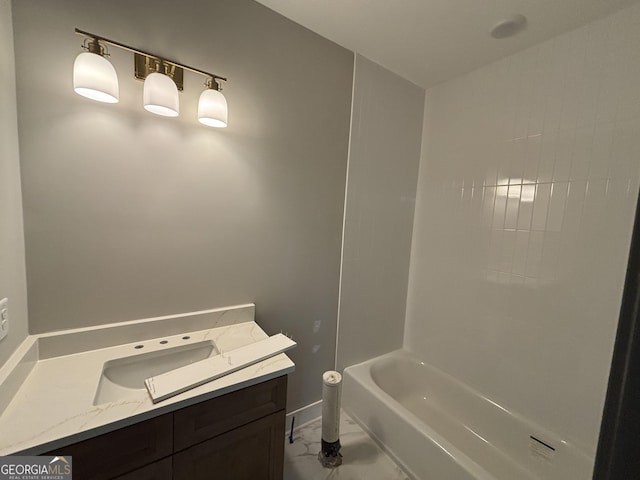 full bathroom with  shower combination, marble finish floor, vanity, and baseboards