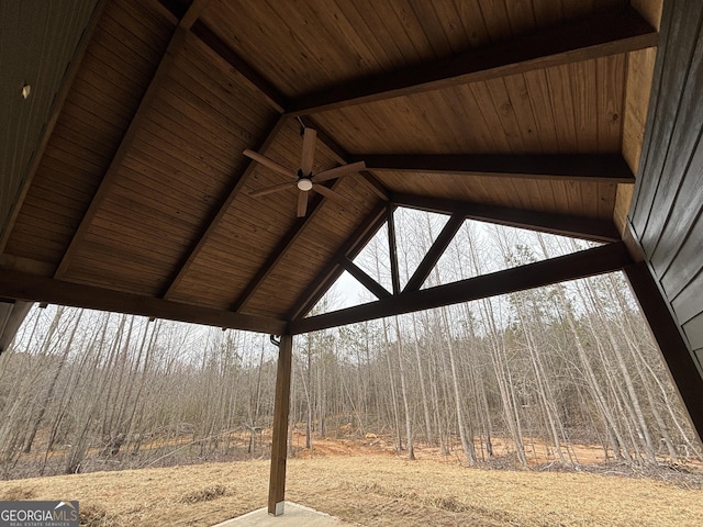 exterior details featuring a ceiling fan and a forest view