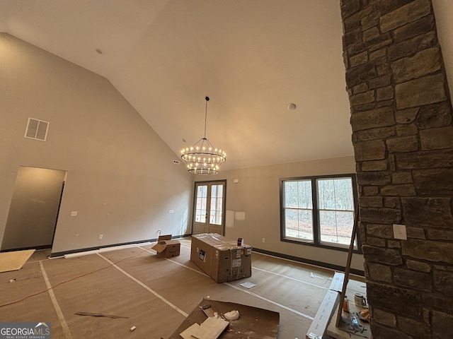 unfurnished dining area featuring high vaulted ceiling, visible vents, baseboards, and an inviting chandelier