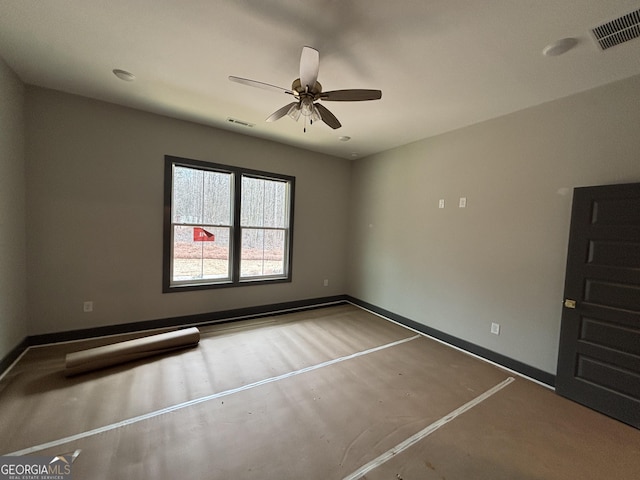 empty room with a ceiling fan, visible vents, baseboards, and wood finished floors