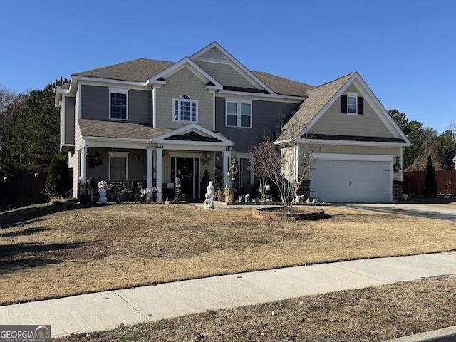 view of front of house with a garage, covered porch, and concrete driveway