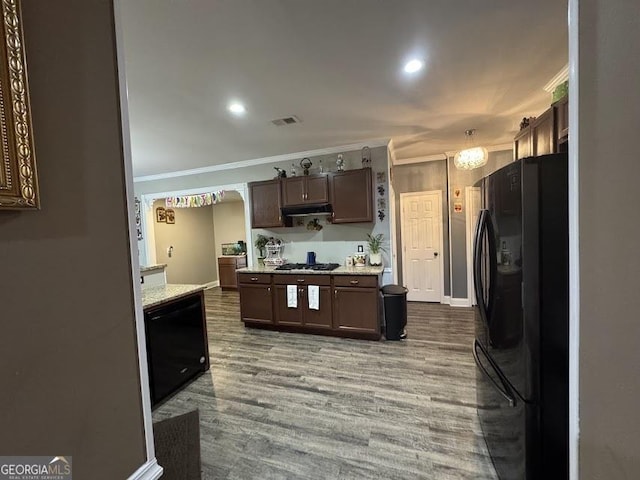 kitchen featuring hanging light fixtures, a notable chandelier, wood-type flooring, black appliances, and ornamental molding