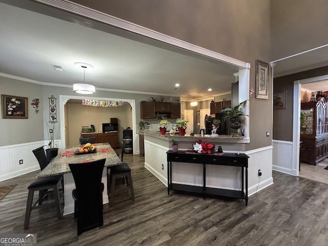 dining area with dark hardwood / wood-style floors and ornamental molding