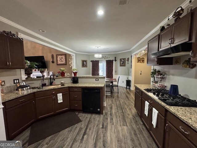 bedroom featuring ceiling fan, wood-type flooring, crown molding, and a tray ceiling