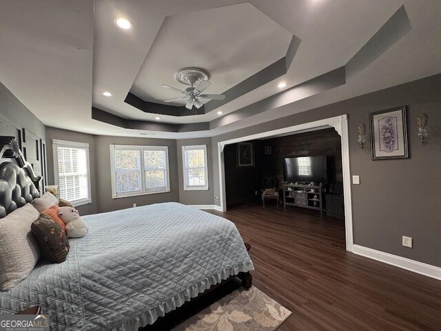 bathroom with a notable chandelier, separate shower and tub, a tray ceiling, vanity, and hardwood / wood-style flooring