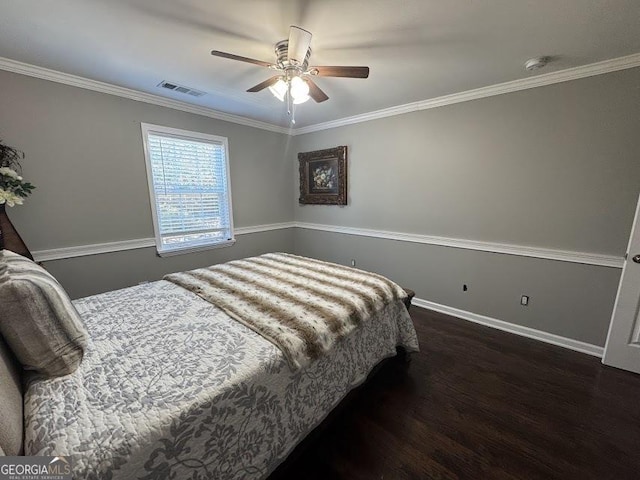 bedroom featuring ceiling fan, dark wood-type flooring, and ornamental molding