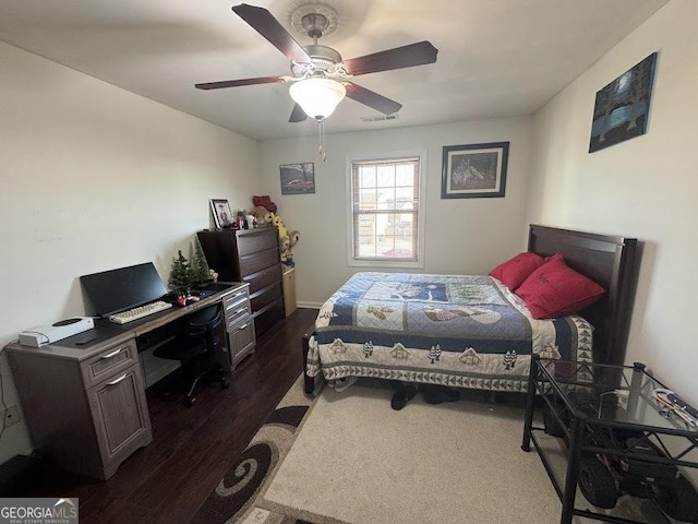 bedroom featuring ceiling fan and dark wood-type flooring