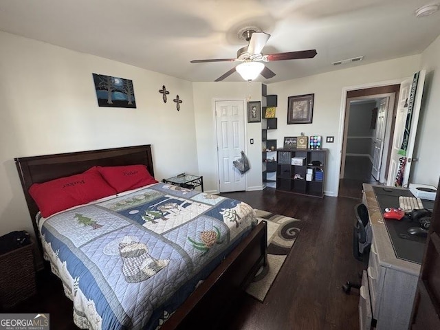 bedroom featuring ceiling fan and dark wood-type flooring