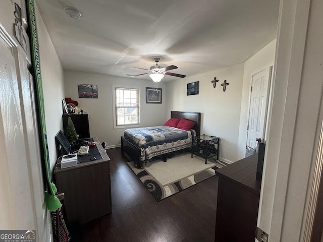 bedroom with baseboards, dark wood finished floors, and a ceiling fan