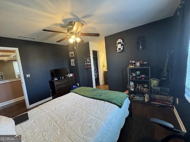 bedroom featuring connected bathroom, ceiling fan, and hardwood / wood-style floors