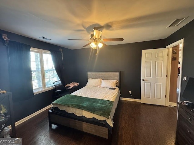 bedroom with ceiling fan and dark wood-type flooring