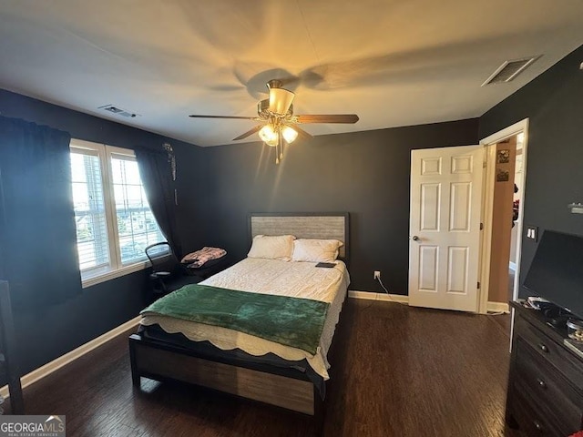 bedroom with ceiling fan and dark hardwood / wood-style floors