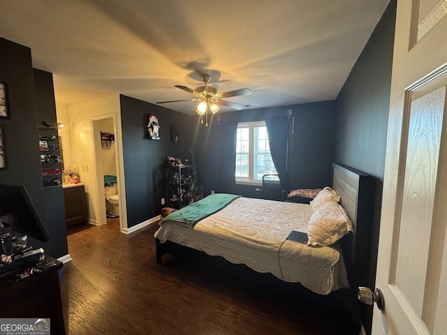 bedroom featuring dark wood-style flooring, ceiling fan, baseboards, and ensuite bathroom