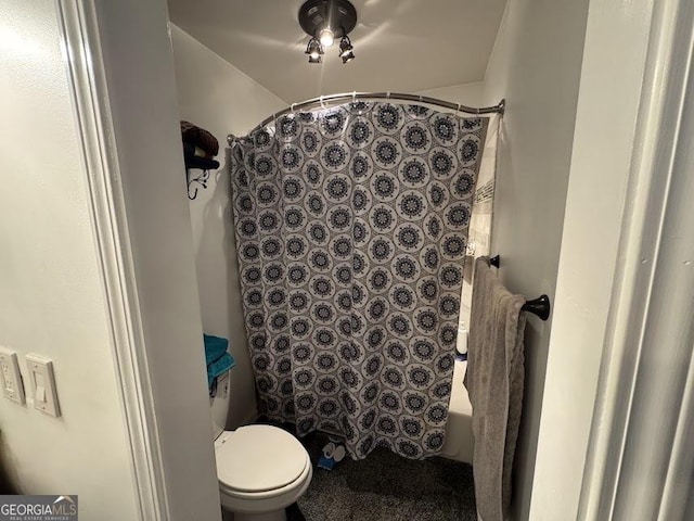 bathroom with shower / tub combo and toilet