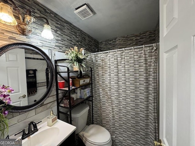 bathroom with decorative backsplash, curtained shower, toilet, and vanity