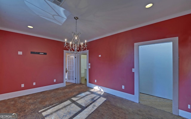 unfurnished dining area with carpet flooring, ornamental molding, and a chandelier