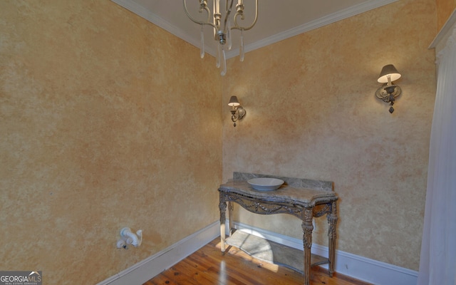 details featuring crown molding, hardwood / wood-style floors, and a chandelier