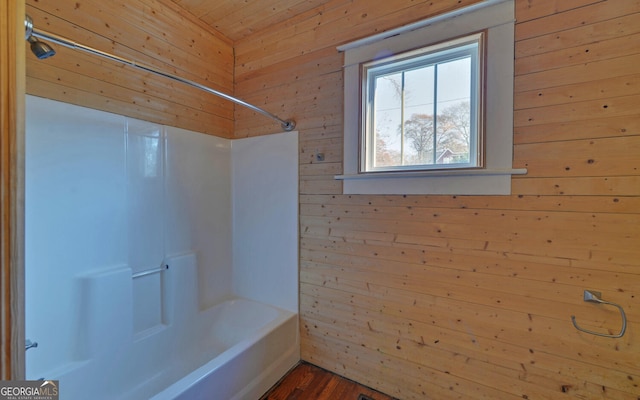 bathroom with shower / tub combination, wooden walls, wood ceiling, and wood-type flooring