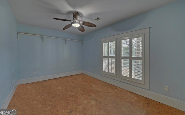 carpeted empty room with ceiling fan