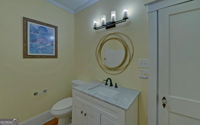 bathroom featuring vanity, toilet, and ornamental molding