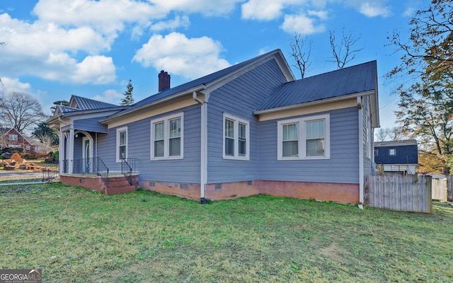 back of house with a lawn