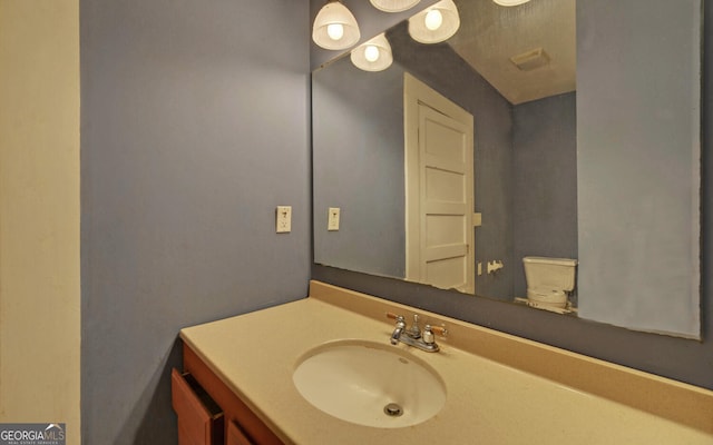 bathroom with vanity and toilet