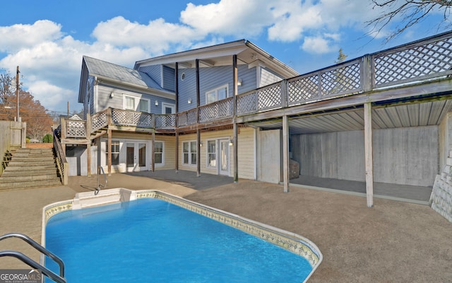 view of swimming pool featuring french doors and a patio