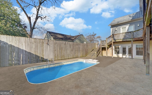 view of pool featuring french doors and a patio