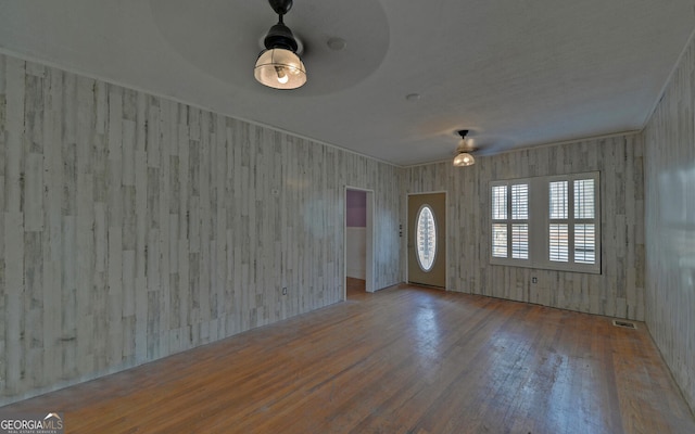 foyer entrance with ceiling fan and hardwood / wood-style flooring