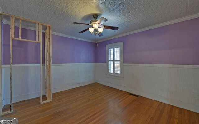 spare room with ceiling fan, wood-type flooring, and crown molding