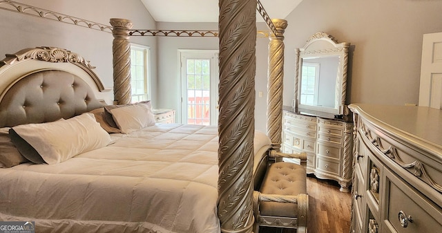 bedroom with lofted ceiling and light wood-type flooring