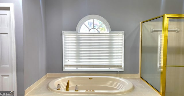 bathroom featuring independent shower and bath