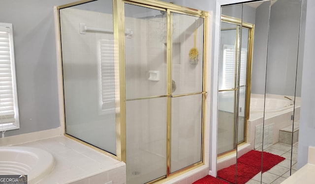 bathroom featuring tile patterned flooring and independent shower and bath