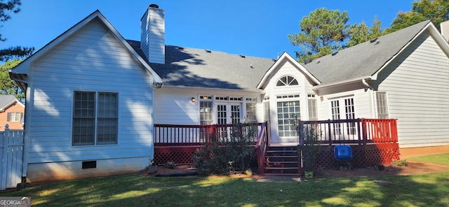 back of house with a wooden deck and a yard