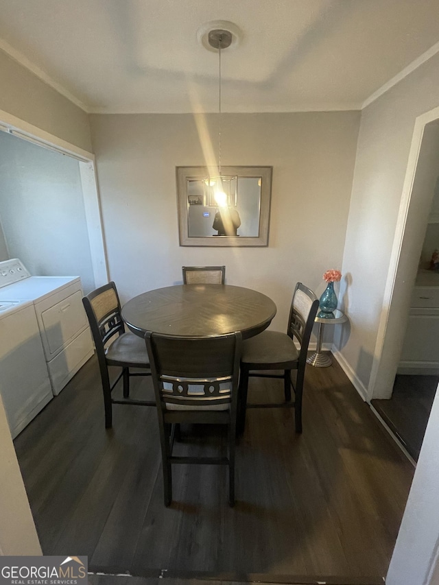 dining space with washing machine and dryer, dark hardwood / wood-style floors, and ornamental molding